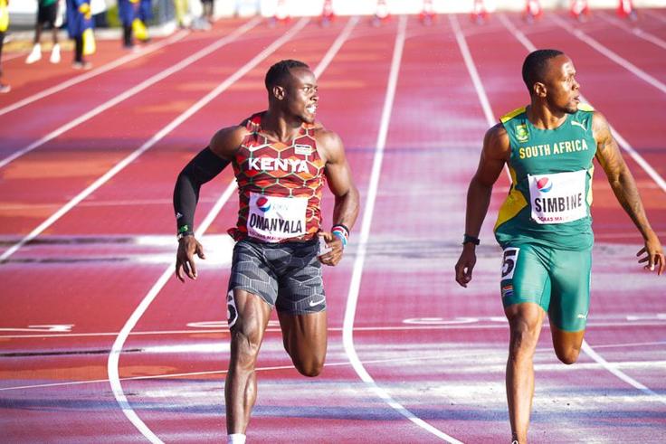 Ferdinand Omanyala at the finish line with Akani Simbine.