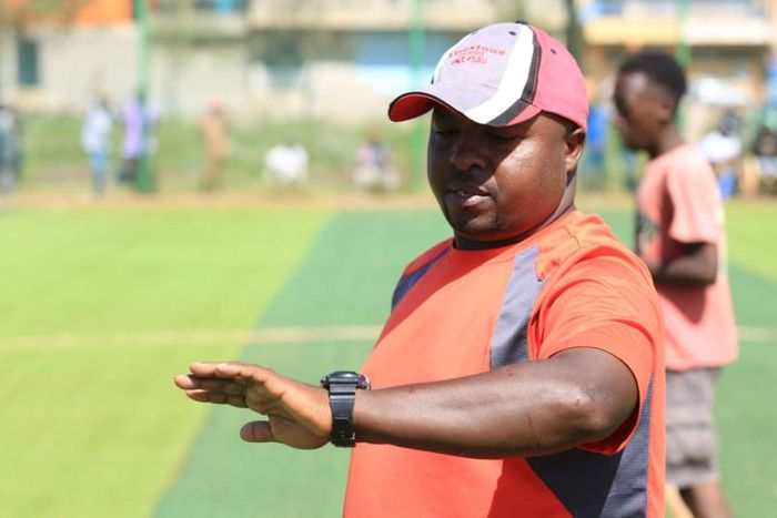 Coach Kitolo checking time on his watch