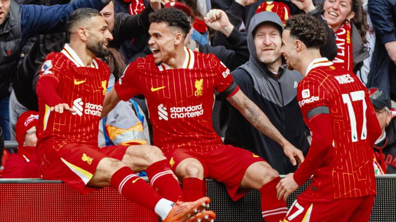MO Salah celebrates with his Liverpool teammates.