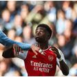 Man City's Josko Gvardiol and Bukayo Saka of Arsenal battle for the ball during a Premier League tie.