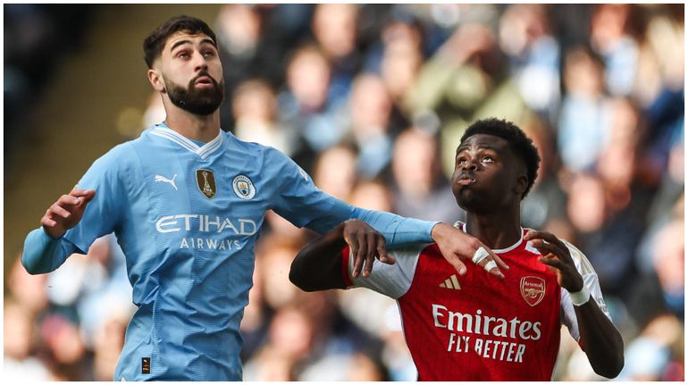 Man City's Josko Gvardiol and Bukayo Saka of Arsenal battle for the ball during a Premier League tie.