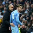 Manchester City manager Pep Guardiola talks to Jack Grealish