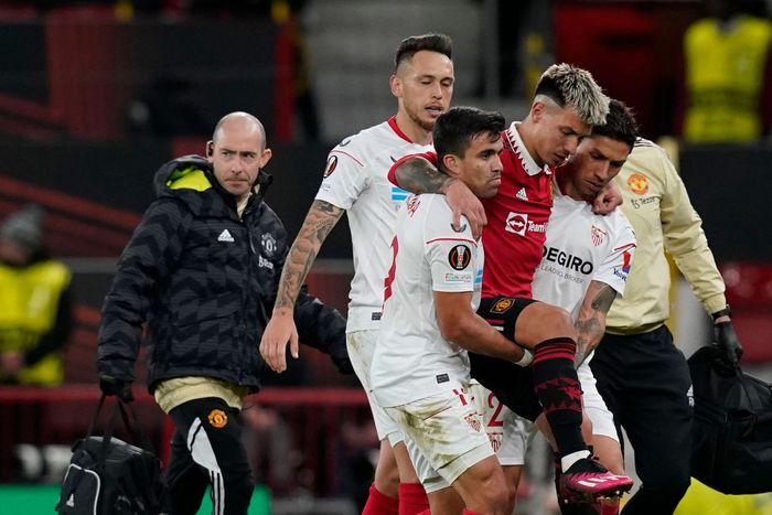 Manchester United's defender Lisandro Martinez leaves the pitch injured.