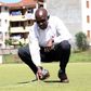 Kenya Hockey Union president Nahashon Randiek shows part of the damaged artificial turf at City Park Stadium in Nairobi on December 11, 2020