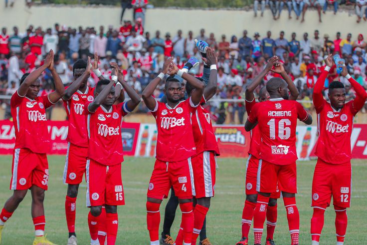 Simba SC players applaud fans.