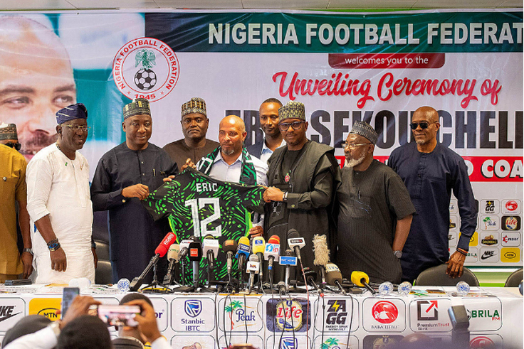 Chairman of the National Sports Commission, Mallam Shehu Dikko and President of NFF, Alhaji Ibrahim Musa Gusau present Chelle a Super Eagles™ jersey during the unveiled the new Head Coach of the Super Eagles, Eric Chelle ||  Image credit: NFF