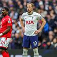 Harry Kane holding his arms around his waist in a match against Nottingham Forest.