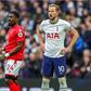 Harry Kane holding his arms around his waist in a match against Nottingham Forest.