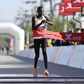 Brian Kwemoi cuts the tape at the 2023 Beijing Half Marathon