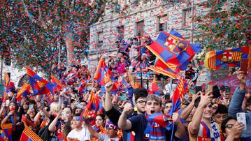 Barca fans celebrate men's and women's teams in style with players in parade