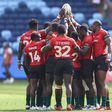 Kenya Sevens gathering for a hurdle before a match.