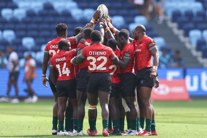 Kenya Sevens gathering for a hurdle before a match.