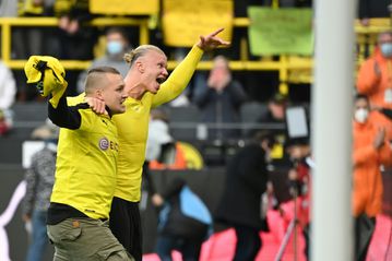 Haaland celebrates with fan after sending Dortmund top