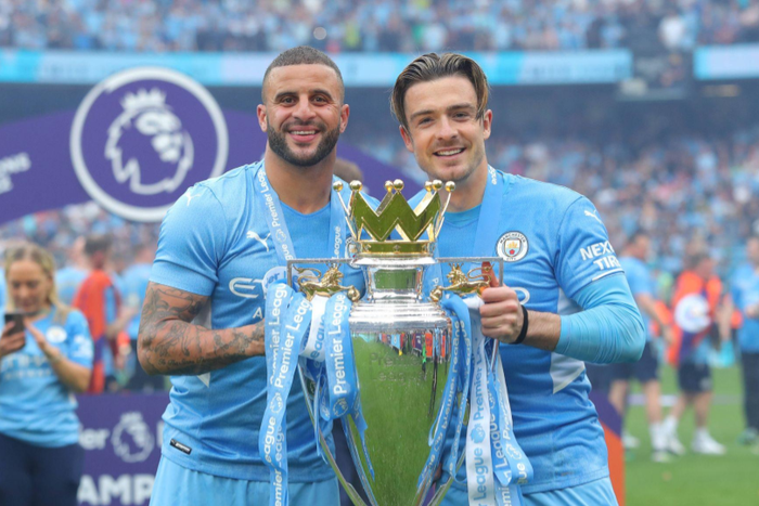 Kyle Walker and Jack Grealish lifting the Premier League trophy