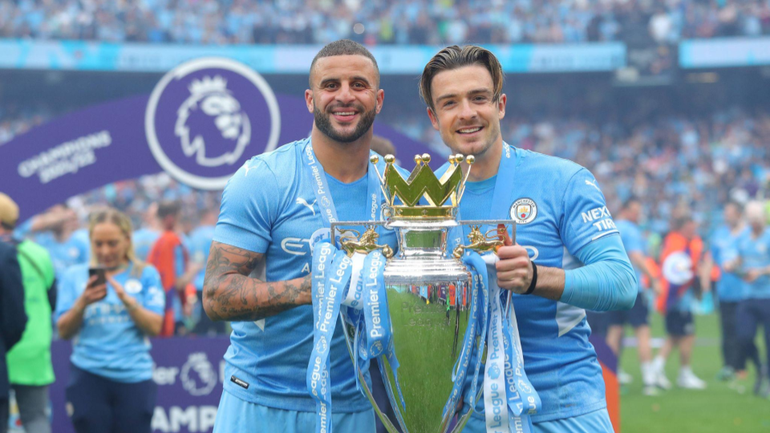 Kyle Walker and Jack Grealish lifting the Premier League trophy