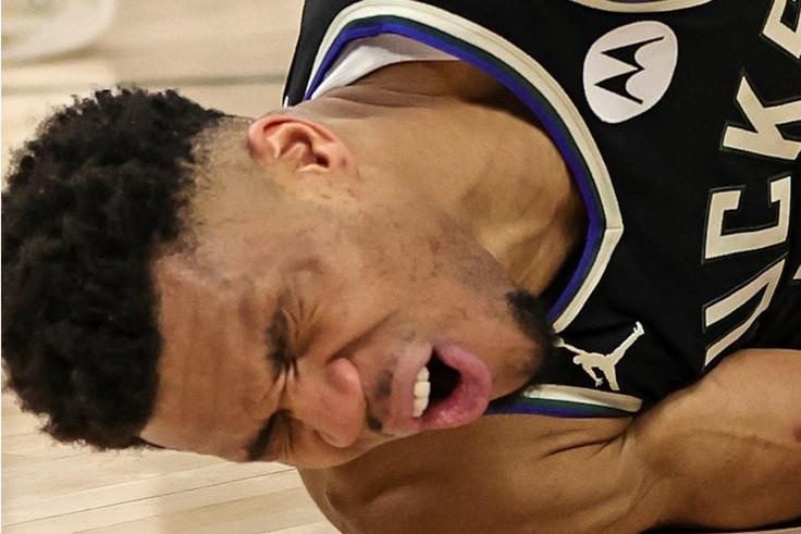 Giannis Antetokounmpo abruptly landed on his back following contact with Kevin Love on a drive to the basket.