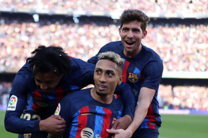 Jules Kounde, Raphinha and Sergi Roberto celebrating a goal
