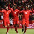 Alphonso Davies celebrating with his teammates after scoring for Canada