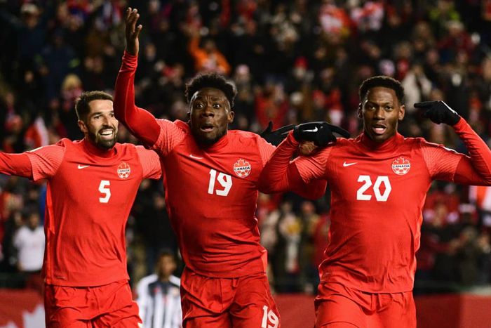 Alphonso Davies celebrating with his teammates after scoring for Canada