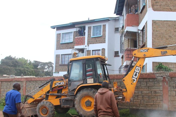 An earthmover demolishing a house in Kitale.