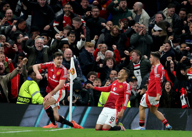 Harry Maguire celebrates Manchester United's winner against Lyon with teammates.