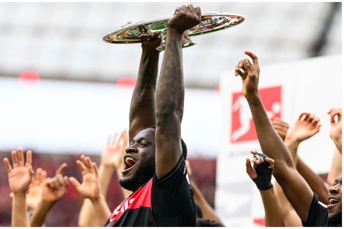 Victor Boniface lifts the historic Bundesliga title at the BayArena.