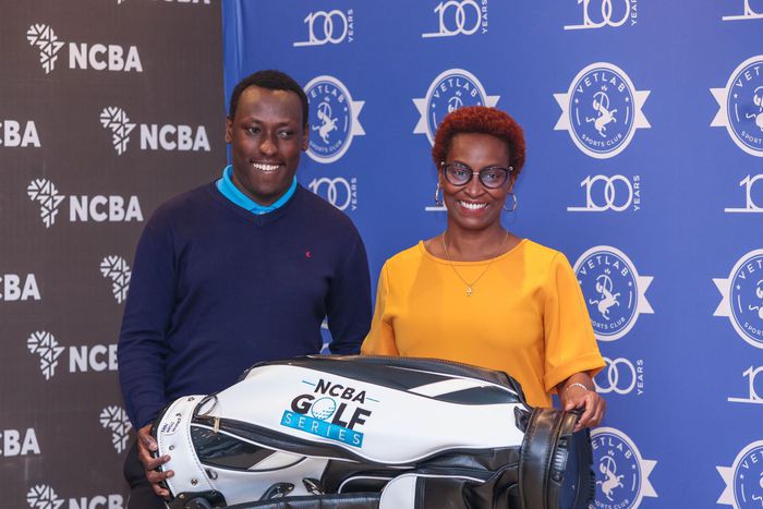 Men's Gross winner Chrispine Owuor receiving his reward