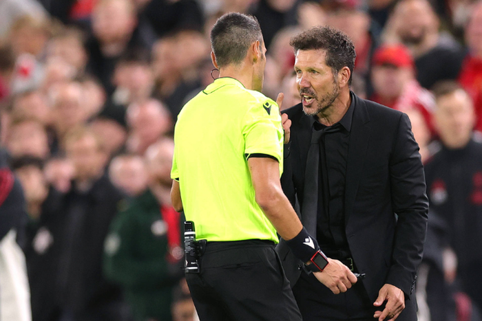 feree Maurizio Mariani and Atletico Madrid coach Diego Simeone argue - Photo: Simon Stacpoole Offside.