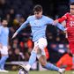 John Stones of Manchester City challenges Jamal Musiala of Bayern Munich.