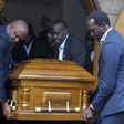 NOCK treasurer Anthony Kariuki and athletes' representative Humphrey Kayange, among other pallbearers, lift the casket of second deputy president Waithaka Kioni at Lee Funeral Home.