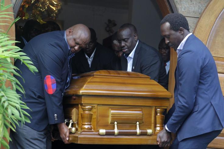 NOCK treasurer Anthony Kariuki and athletes' representative Humphrey Kayange, among other pallbearers, lift the casket of second deputy president Waithaka Kioni at Lee Funeral Home.