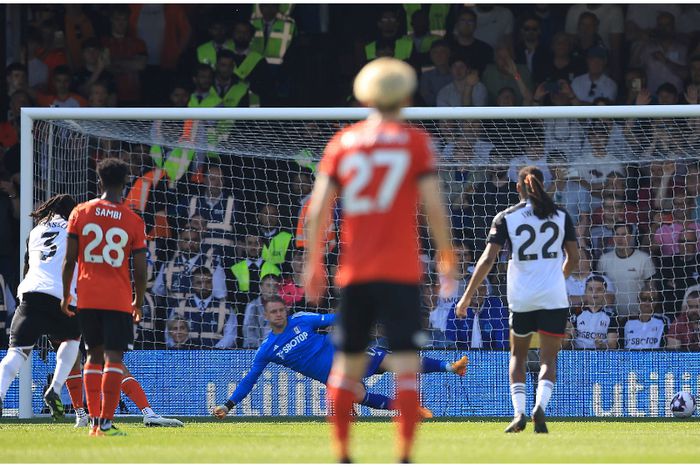 Calvin Bassey and Alex Iwobi watch on against Luton Town.