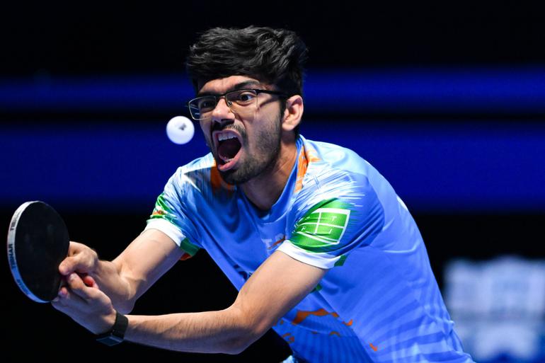 Manav Thakkar reacts in a tennis match.