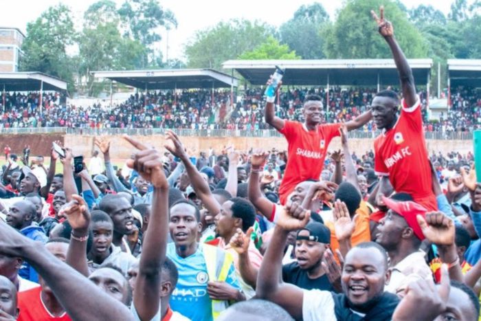 Shabana FC fans carry players aloft after securing top flight promotion.