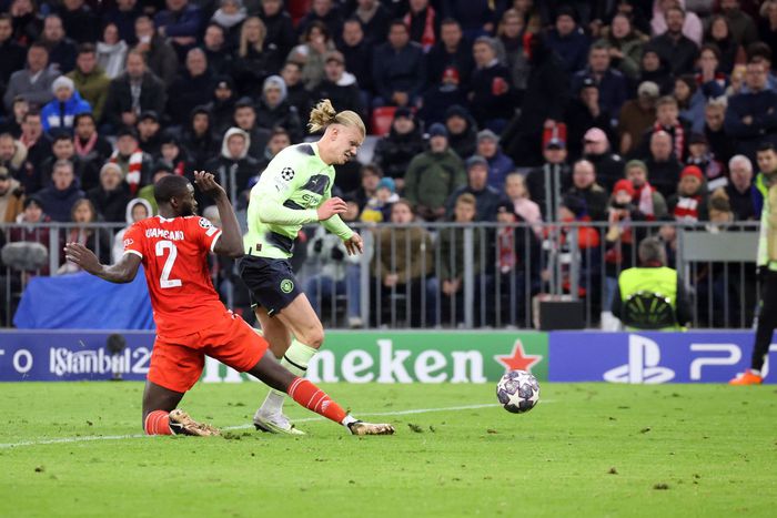 Bayern Munich defender Dayot Upamecano tackles Erling Haaland of Manchester City.