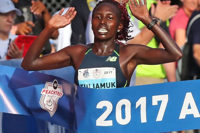 Aliphine Tuliamuk hits the finish line to win the women s division in the 48th running of the AJC Peachtree Road Race in 2017.