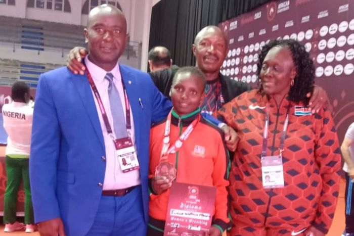 Eunice Mburu of Kenya (centre) after winning bronze at the Africa Wrestling Championships.
