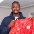 Arthur Okonkwo is holding the Super Eagles kit after his unveiling.