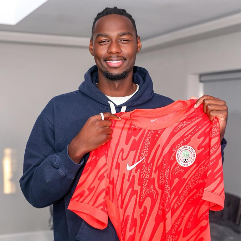 Arthur Okonkwo holding the Super Eagles kit.