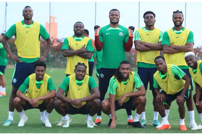 The Super Eagles stars led by Stanley Nwabali and Alex Iwobi celebrate winning a session.