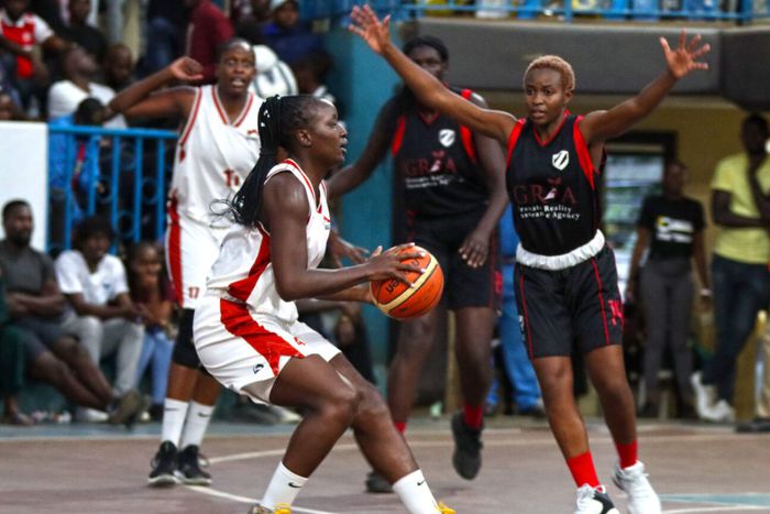 Equity Hawks Skipper Melissa Akinyi with the ball as Zetech's Ashley Minayo guards her closely