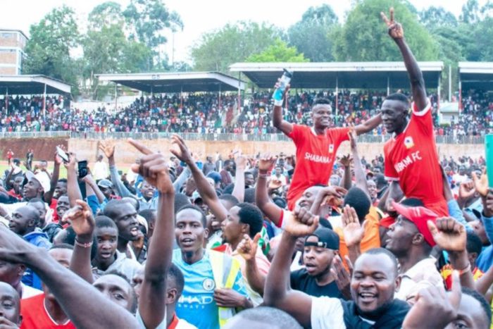 Shabana supporters celebrate with players after securing top flight promotion.