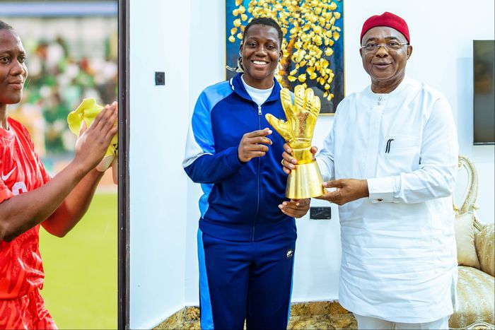 Super Falcons goalkeeper Chiamaka Nnadozie presents her CAF Award to the Imo State Governor and First Lady.