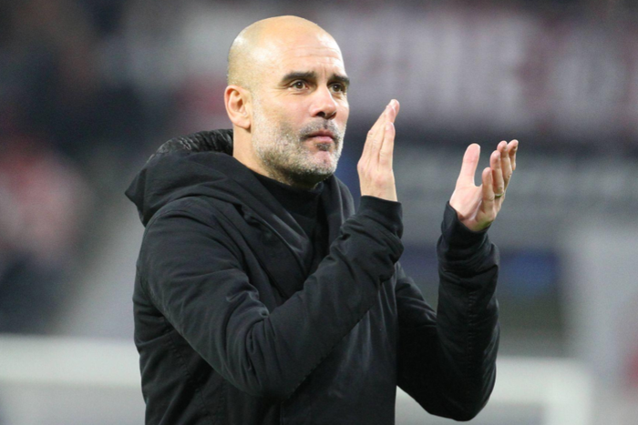 Pep Guardiola applauds the visiting fans after the draw against Leipzig