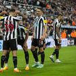 Newcastle players celebrate a goal together