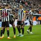 Newcastle players celebrate a goal together