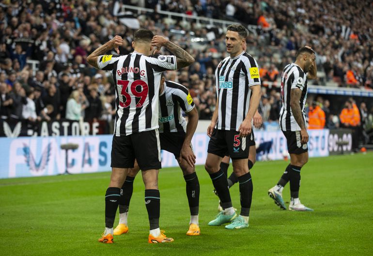Newcastle players celebrate a goal together