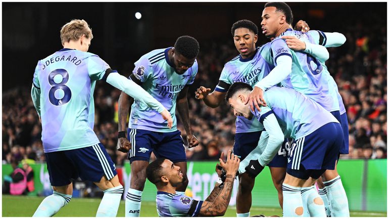 Arsenal players surround Gabriel Jesus after his brace against the Eagles.