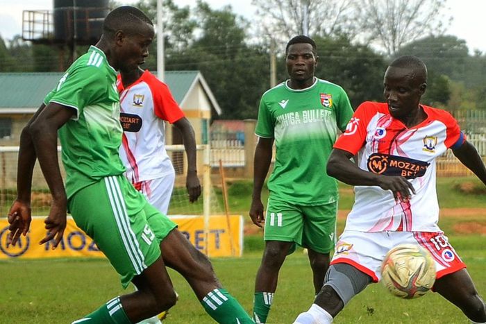 Kakamega Homeboyz Moses Mudavadi sandwiched by Vihiga Bullets players