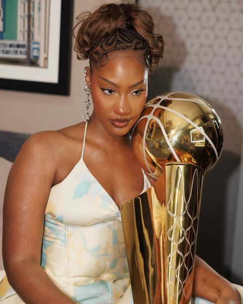 Nigerian Afrobeats star Tems poses with NBA Larry O’Brien Championship Trophy.